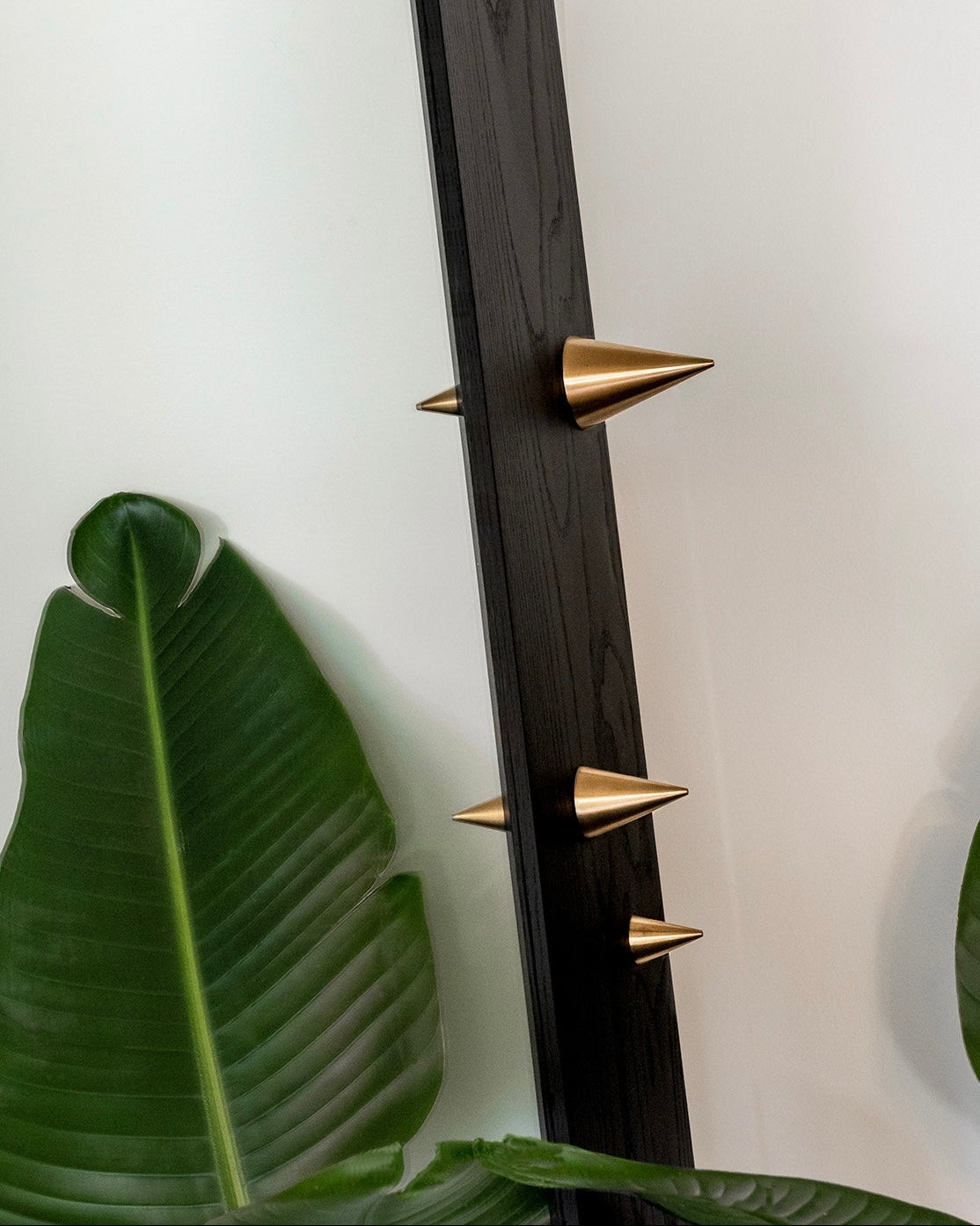 Decorative wall piece with gold spikes on a white background